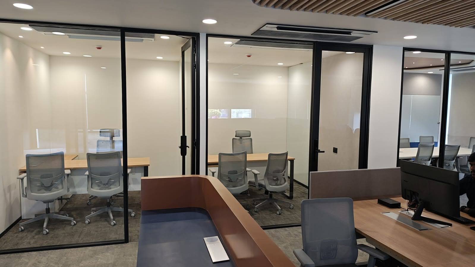 Glass, light, and a clean desk.